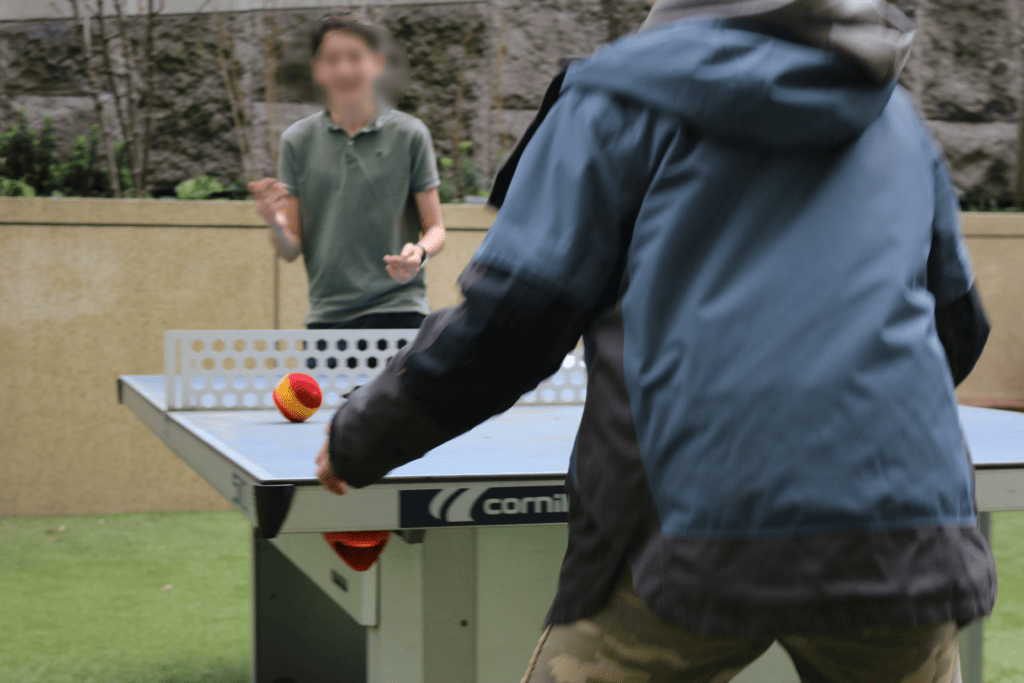 Pair of young boys playing table tennis with hand-knit anti-stress balls at BioBeo Festival